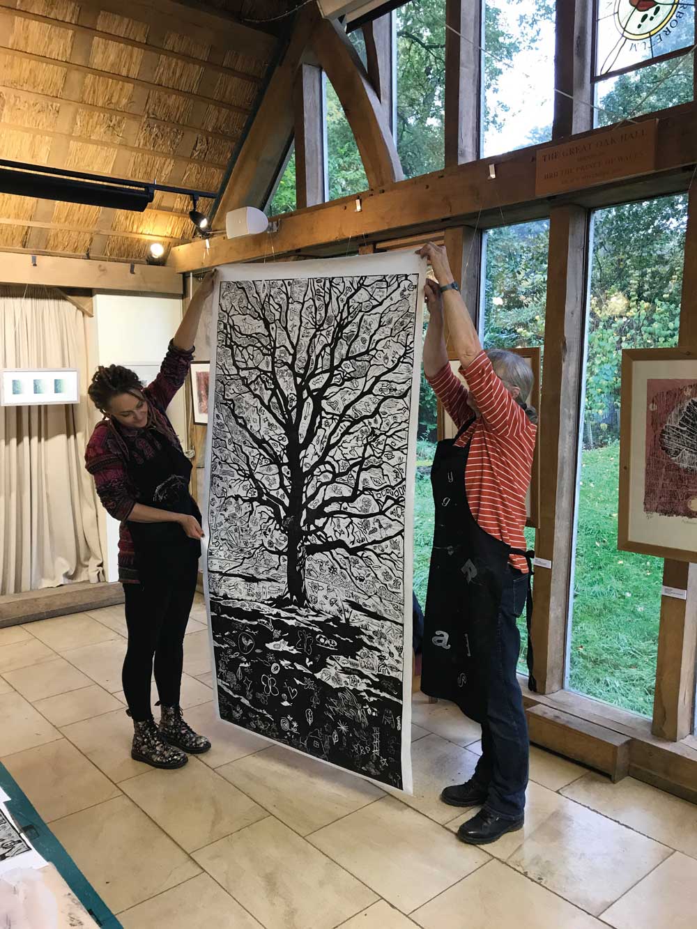 Lino print of a winter oak tree being held up