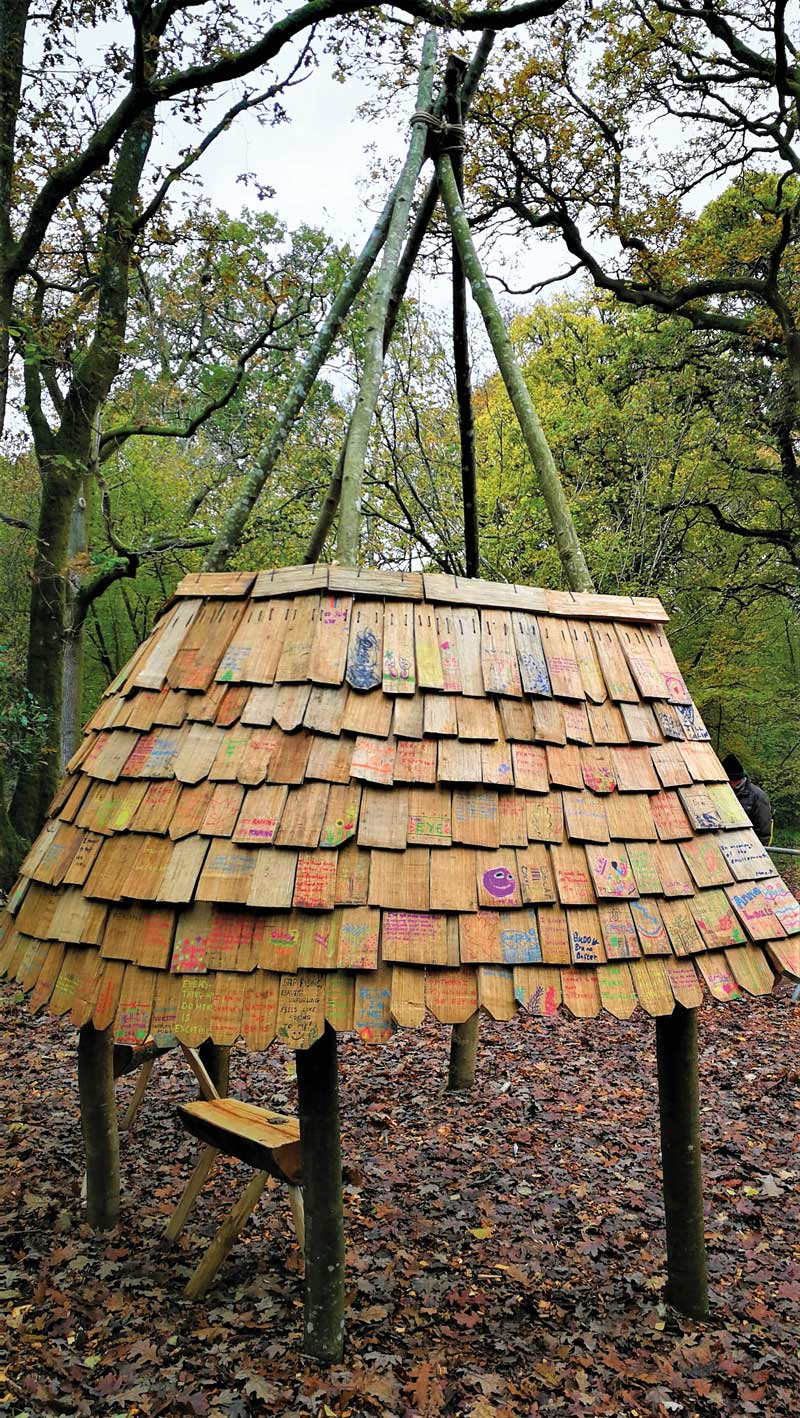 Shingle shelter structure similar to a tipi with shingle tiles decorated with quotes and thoughts