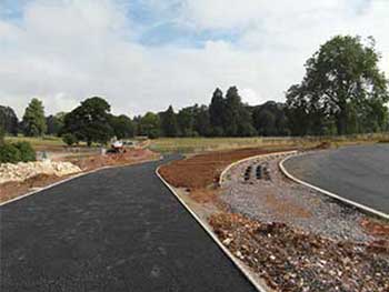 Footpath to Welcome Building with a base layer of bitmac ready for the final resin bound gravel layer. The row of pipes mark the locations of our new bicycle racks which will be installed in the next few days.