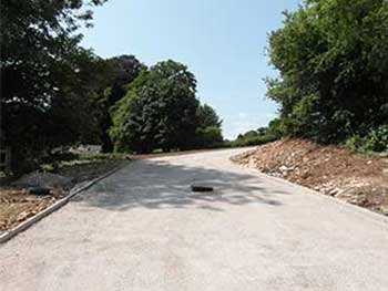 The marker in the middle of the road will be the new location for Island barriers for staff to access and depart the site.