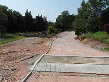 Here is one of our speed humps under construction. In the background on the left you can see the Plant centre pick up parking, as well as the crosses  on the left that show where the low gradient ramp is going to be.