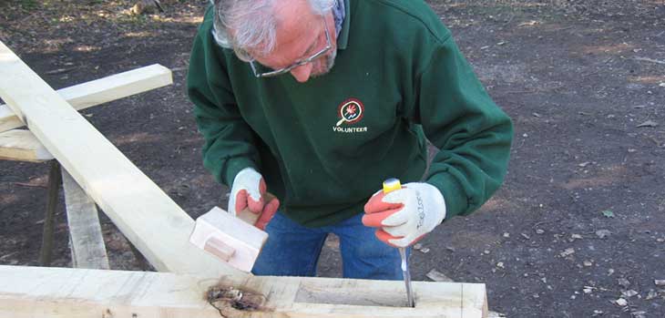 Michael Goom cutting housing in tie beam for roof A frame