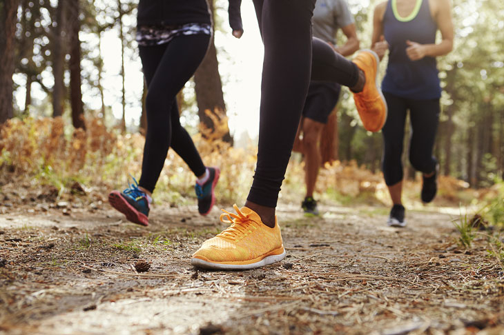 A group of runners on a trail path